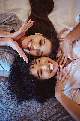 Buy stock photo Top view, women or bonding on house bed, home or hotel for sleepover fun, skincare spa vacation or girls holiday. Smile, happy girls or playful friends lying in luxury bedroom and perfect facial skin