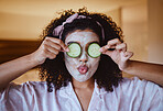 Cucumber, eyes and skincare facial for black woman in a bedroom, grooming and having fun with treatment. Face, mask and girl relax with fruit product, hygiene and beauty routine, happy and playful