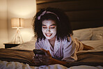 Skincare, face mask and woman on a phone in her bedroom networking on social media or mobile app. Beauty, self care and female browsing the internet or typing a message while relaxing on her bed.