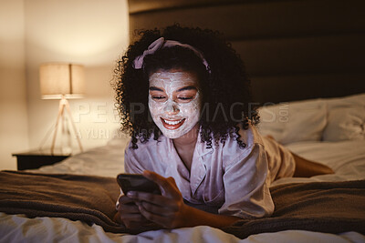 Buy stock photo Skincare, face mask and woman on a phone in her bedroom networking on social media or mobile app. Beauty, self care and female browsing the internet or typing a message while relaxing on her bed.
