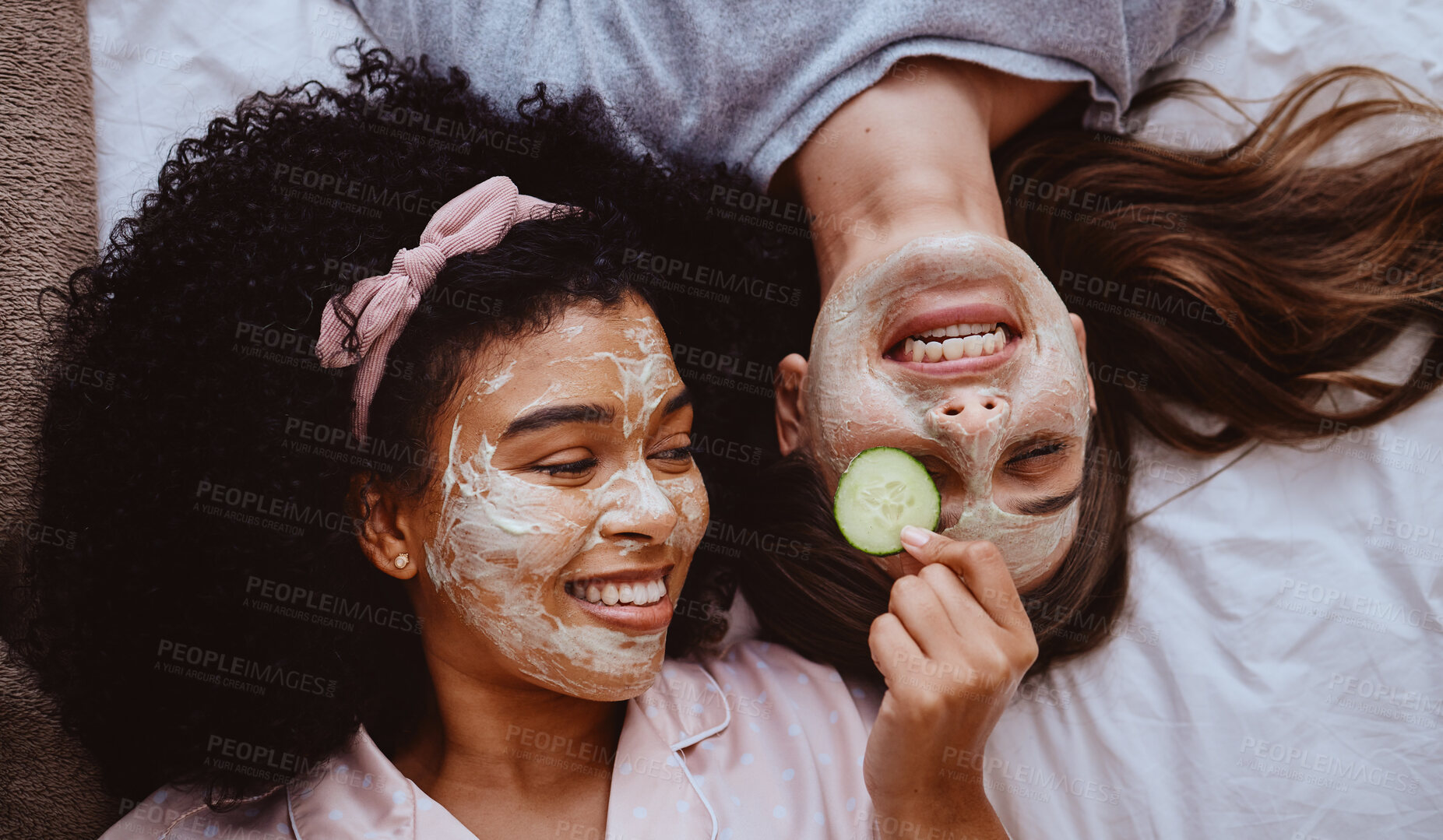 Buy stock photo Facial, cucumber or beauty with girl best friends lying on the floor together for treatment at a sleepover. Face mask, skincare or natural care with a female and friend at home to relax while bonding