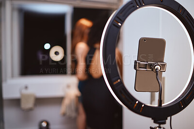 Buy stock photo ring light, phone and woman influencer equipment with friends live streaming getting ready. Night, creative gen z content and internet production tech with blurred background and mockup in a home 