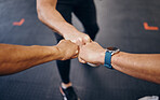 Group fist bump, hands and gym for motivation with personal trainer for health, wellness or training with smartwatch. Team, workout or exercise for fitness goal, muscle development or body healthcare