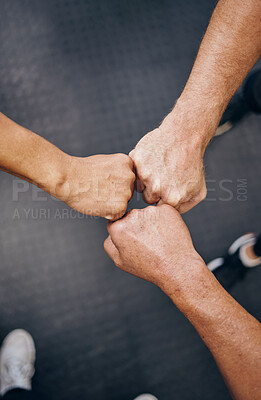 Buy stock photo Hands, motivation and collaboration with people in the gym from above for health, fitness or solidarity. Teamwork, training and partnership with an athelte group doing a fist bump together for unity