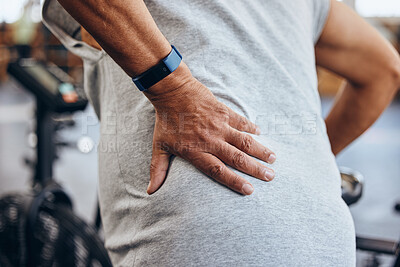 Buy stock photo Fitness, gym and old man with hand on back pain, emergency during workout at sports studio. Health, wellness and inflammation, zoom on senior person hands on muscle cramps while training or exercise.
