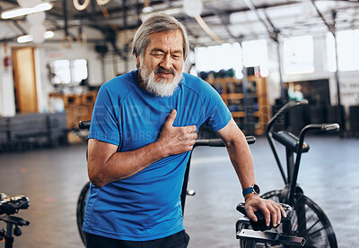 Buy stock photo Fitness, gym and old man with pain in chest, medical emergency during workout at sports studio. Exercise, health and wellness, stress and asian senior person with hand on heart muscle while training.