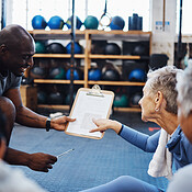 Happy Group Of People At The Gym With Trainer And Senior Women