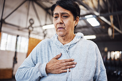 Buy stock photo Senior woman with chest pain or injury in the gym after a intense workout or training. Healthcare, sick and elderly lady in retirement with asthma or breathing problem during exercise in sport center