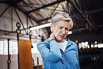 Neck pain, senior woman and injury in gym after exercise, workout or training accident. Sports, wellness and elderly female with fibromyalgia, inflammation or painful muscles after exercising alone.