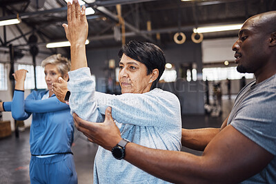 Buy stock photo Fitness, personal trainer and senior women stretching before a wellness workout in a training studio. Health, warm up and elderly female friends in retirement doing a exercise with male coach in gym.