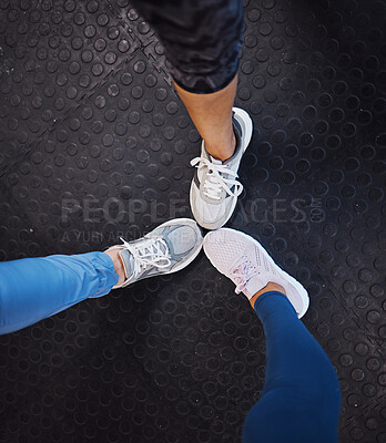 Buy stock photo Women, gym and shoes on floor in circle for teamwork, motivation and support for fitness training. Woman exercise group, sneakers and huddle for team building, solidarity and workout in top view