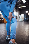 Leg injury, accident and pain at a gym after workout, training or sport exercise with bruise. Fitness, sports and woman athlete limping from a swollen, inflammation or sprain muscle at a studio.