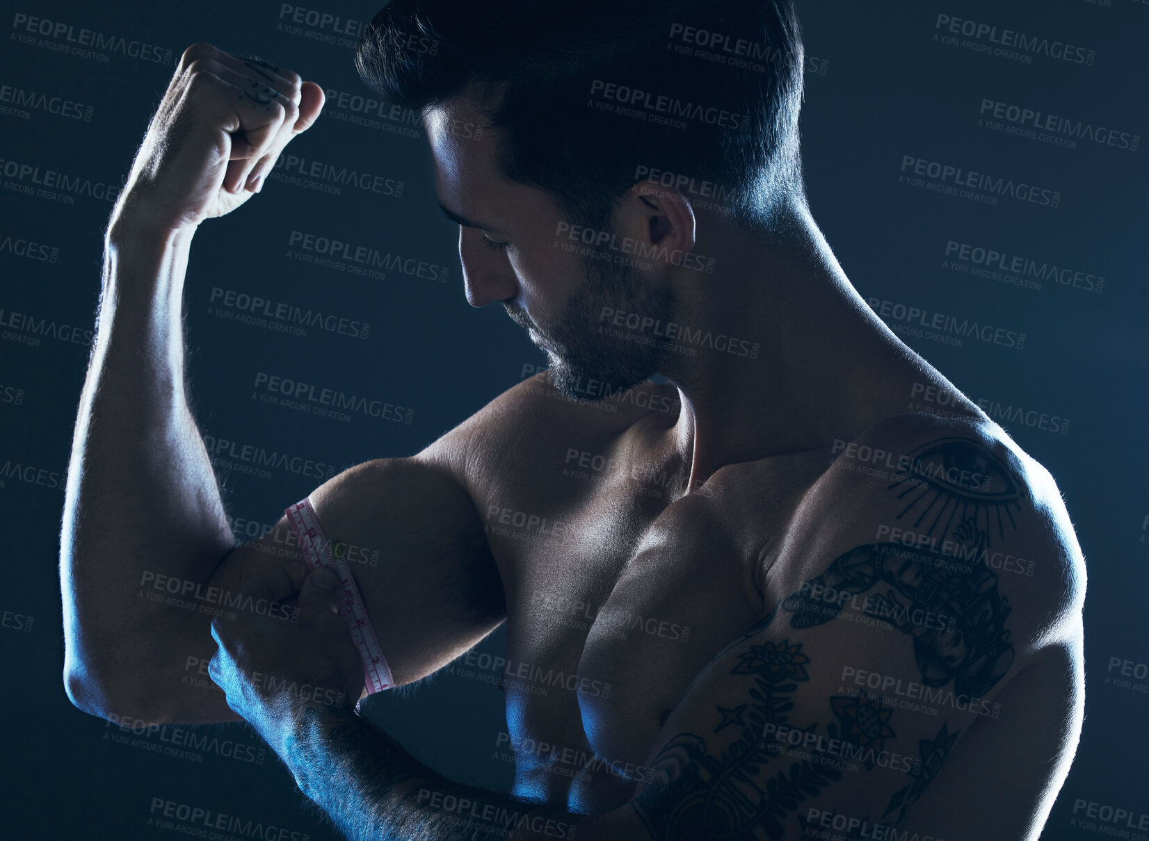 Buy stock photo Muscle, showing and man with arms in the dark for fitness isolated on a studio background. Exercise, training and muscular bodybuilder flexing a bicep for workout results, performance and progress