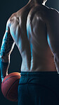 Sports, body and back of man with ball on black background, isolated with neon blue light and basketball. Fitness, muscle and topless male model in artistic dark studio for workout and gym aesthetic.