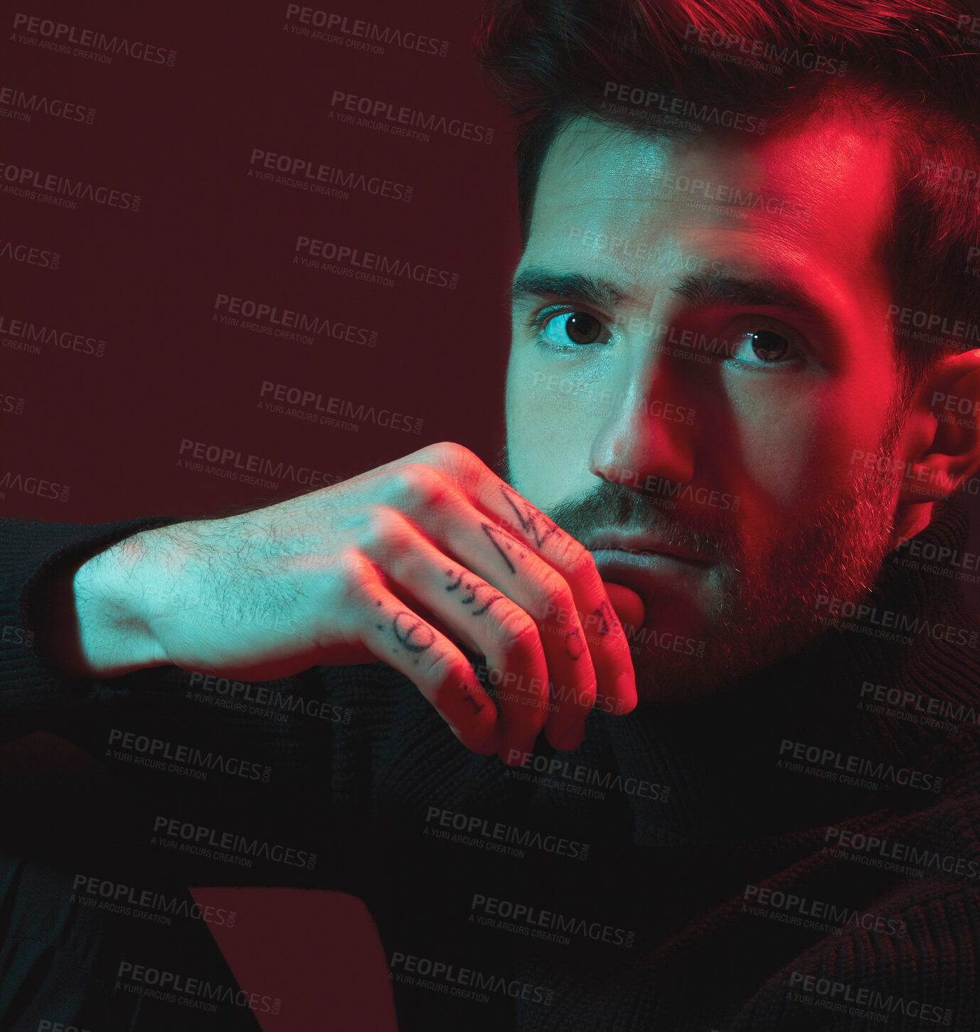 Buy stock photo Man, fashion and studio portrait with red light for clothes, hand tattoo and luxury style on dark background. Face of aesthetic model person with turtle neck, art and cosmetic for inspiration for men