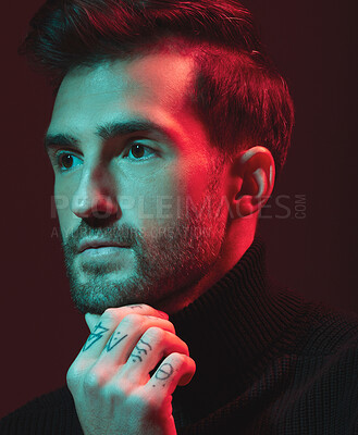 Buy stock photo Idea, fashion and red with a handsome man model in studio on a dark background for contemporary beauty. Face, thinking and art with a young male posing indoor to promote trendy clothes or style