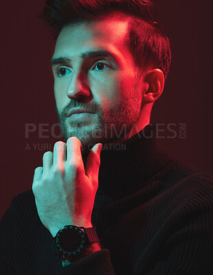 Buy stock photo Idea, beauty and red with a handsome man model in studio on a dark background for contemporary fashion. Face, thinking and art with a young male posing indoor to promote trendy clothes or style