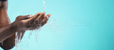 Buy stock photo Water, black man and cleaning hands with mockup space, wash face and skincare isolated on blue background. Healthy skin, clean cosmetics and grooming, hygiene and beauty sustainability in studio