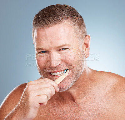 Buy stock photo Happy, mouth or old man brushing teeth with dental toothpaste products for healthy oral hygiene in studio. Eco friendly, portrait or senior person cleaning gums with a natural bamboo wood toothbrush 