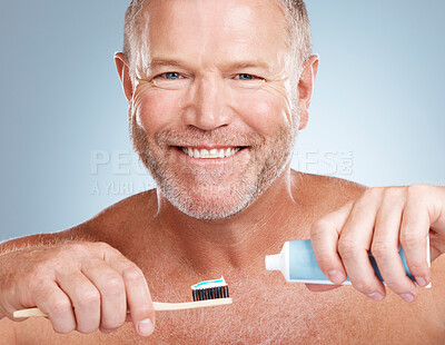 Buy stock photo Portrait, toothpaste or old man brushing teeth with dental products in a healthy oral hygiene grooming in studio. Face, smile or happy senior guy cleaning mouth with a natural bamboo wood toothbrush 
