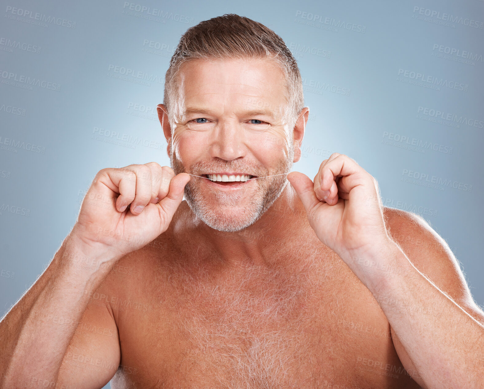 Buy stock photo Floss, portrait and man with oral hygiene to clean mouth, wellness and guy against blue studio background. Male, gentleman and string for fresh breath, dental health and morning routine or grooming