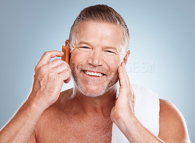 Buy stock photo Skincare, grooming beard and portrait of man with comb for wellness, cleaning and hygiene on blue background. Salon aesthetic, beauty and face of male with barber tools for facial, hair care and skin