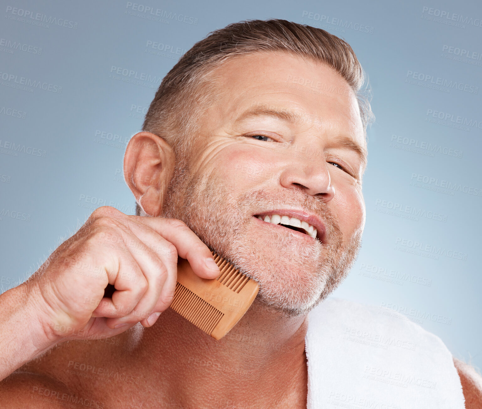 Buy stock photo Skincare, grooming and man with comb for beard for wellness, healthy skin and hygiene on blue background. Beauty aesthetic, cleaning and face portrait of male with barber tools for facial hair care
