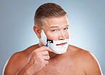 Shaving cream, face and man with razor in studio isolated on a gray background for hair removal. Portrait, skincare and  mature male model with facial foam to shave for aesthetics, health or wellness