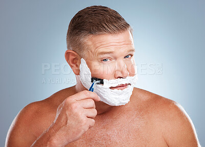 Buy stock photo Shaving cream, face and man with razor in studio isolated on a gray background for hair removal. Portrait, skincare and  mature male model with facial foam to shave for aesthetics, health or wellness