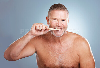 Buy stock photo Smile, portrait or senior man brushing teeth with dental toothpaste for healthy oral hygiene grooming in studio. Eco friendly, happy or mature guy cleaning mouth with a natural bamboo wood toothbrush