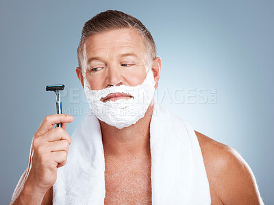 Buy stock photo Skincare, razor and old man shaving in studio with foam, beauty or grooming on grey background. Face, doubt and mature male model relax for luxury, hair removal and facial, skin and product isolated