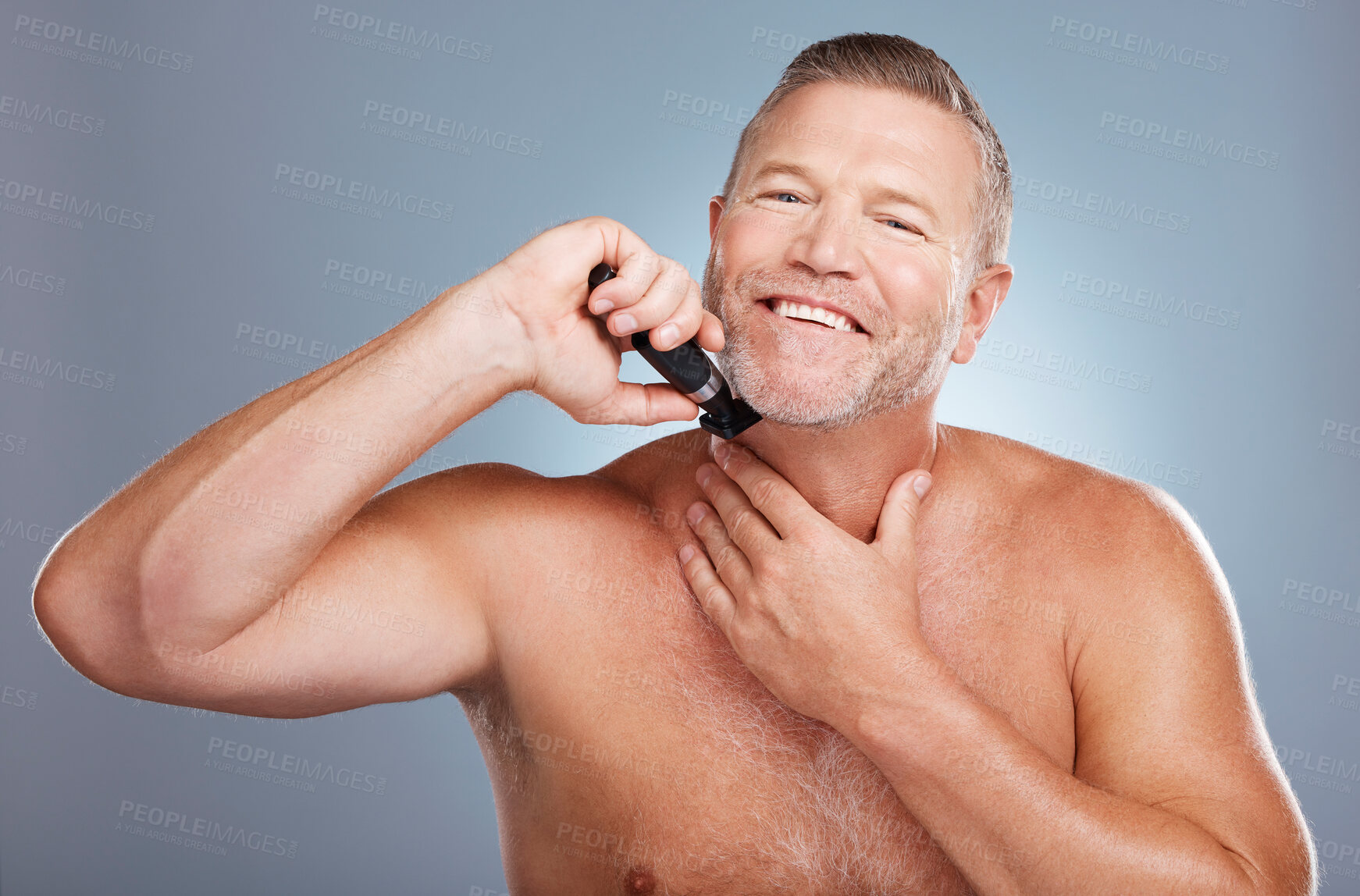 Buy stock photo Grooming, skincare and portrait of man with razor for beard for wellness, facial and hygiene on blue background. Barber, cleaning and face of male with shaver for self care, healthy skin and haircare