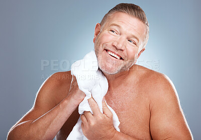 Buy stock photo Happy, old man and skincare in studio with towel for face, cleaning or grooming on grey background. Facial, mature and male model relax for luxury, skin or beauty, wrinkles or treatment and isolated