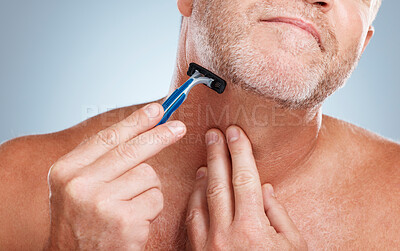 Buy stock photo Grooming, razor and man shaving his beard in a studio for a facial, skincare and epilation routine. Health, wellness and mature male doing face hair removal treatment for self care by gray background