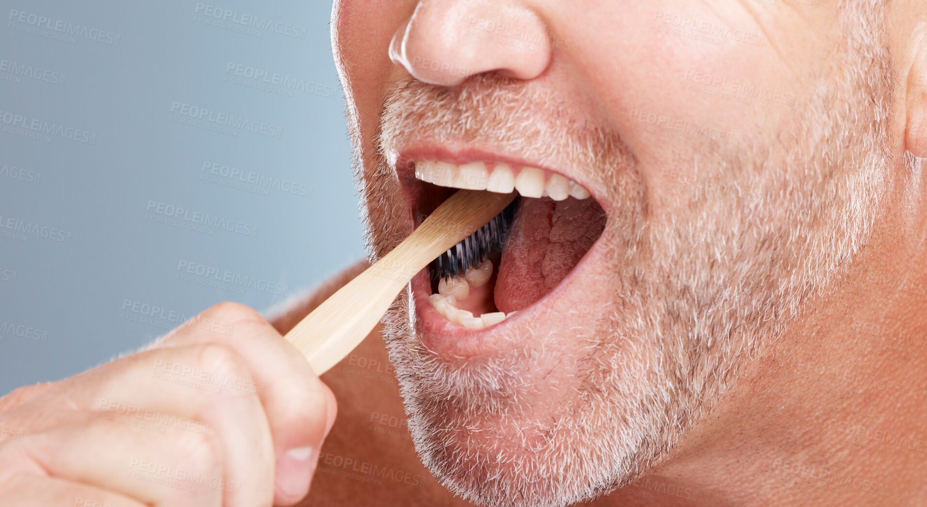 Buy stock photo Cleaning, mouth or hand brushing teeth with dental toothpaste for healthy oral hygiene grooming in studio. Eco friendly, zoom or senior man with a natural bamboo wood toothbrush for teeth whitening 