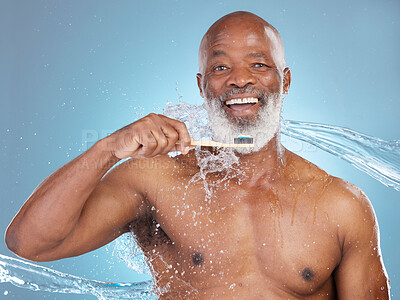 Portrait, water splash and black man with toothbrush, toothpaste or dental hygiene for wellness, brushing and blue studio background. Senior African American male, guy and clean teeth for oral health