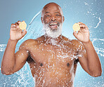 Black man, portrait smile and fruit for vitamin C, skincare nutrition or hydration against a blue studio background. Happy African American male smiling and holding grapefruit for health and wellness