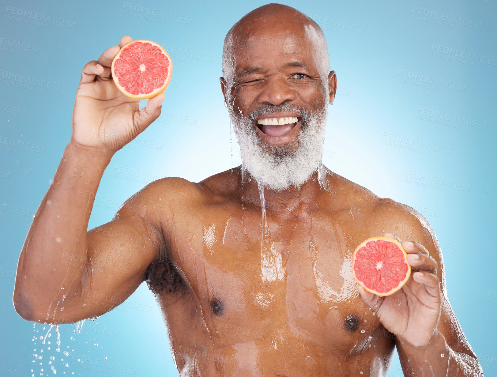 Buy stock photo Black man, portrait smile and fruit for nutrition, vitamin C or skincare hydration against a blue studio background. Happy African American male smiling and holding grapefruit for health and wellness