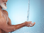 Water splash, mock up and black man cleaning hands with smile, wellness and hygiene in studio. Fresh, clean and shower, male skincare isolated on blue background with product placement and health.