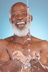 Shower, catching and hands of a black man with water for sustainability isolated on a blue background. Smile, clean and senior African person saving liquid from washing in palm on a studio backdrop