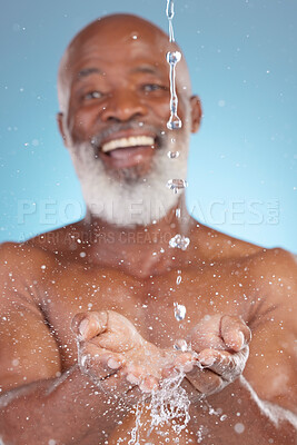 Buy stock photo Shower, catching and hands of a black man with water for sustainability isolated on a blue background. Smile, clean and senior African person saving liquid from washing in palm on a studio backdrop