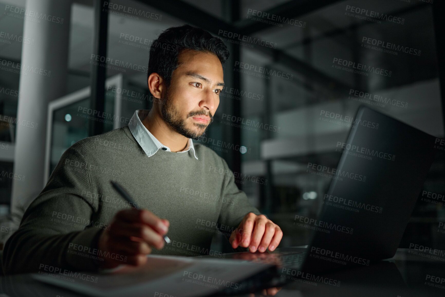 Buy stock photo Business man, laptop and writing notes in office while working on project deadline at night. Overtime, planning or male employee write information on paper for research on computer in dark workplace.