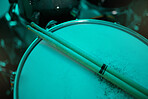 Top view of sticks on drums instrument in music studio, production or live band in neon green light. Background closeup of drum kit of musician, concert and sound performance to record at talent show