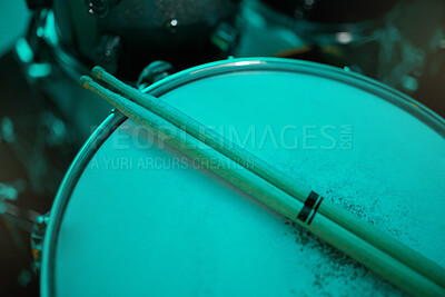 Buy stock photo Top view of sticks on drums instrument in music studio, production or live band in neon green light. Background closeup of drum kit of musician, concert and sound performance to record at talent show