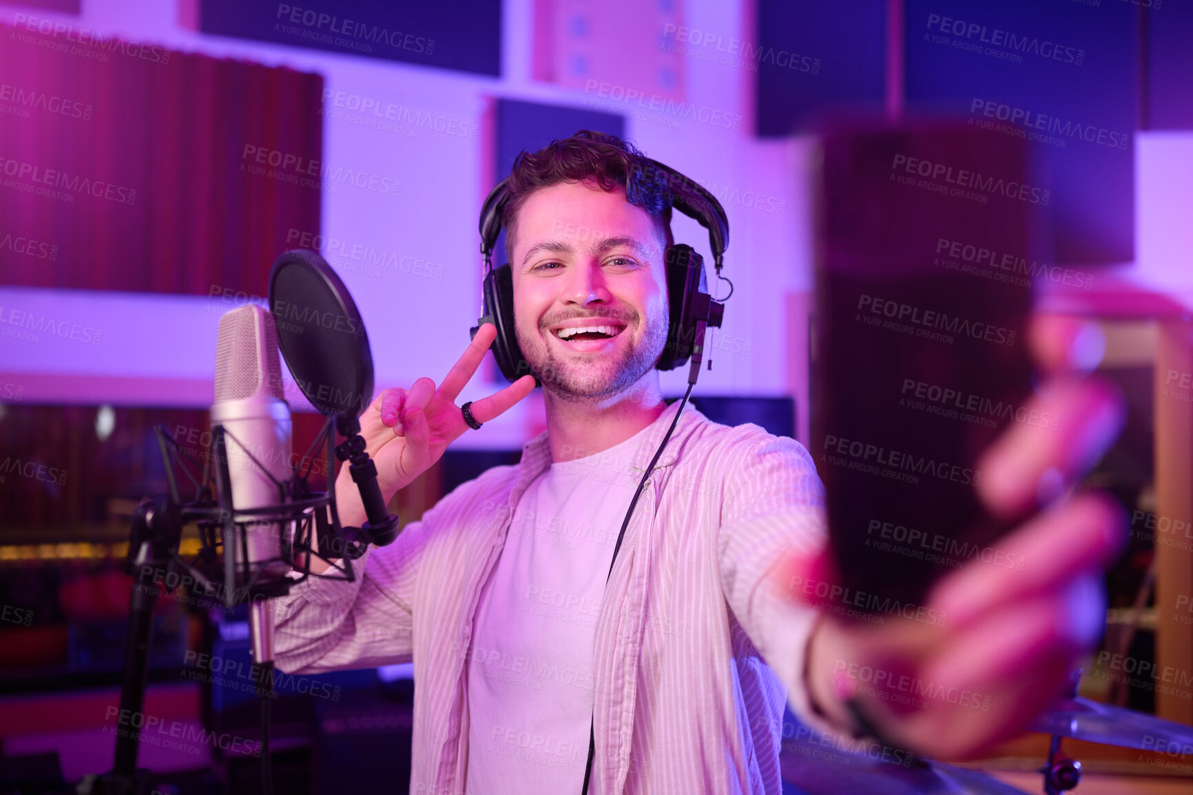 Buy stock photo Singer in recording studio, selfie and portrait with peace hand sign, music with mic and headphones. Social media content, happy in picture and audio, podcast or radio dj with man smile with phone