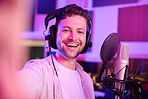 Musician in recording studio, selfie and portrait with smile, making music with microphone and headphones. Social media content, happy in picture and audio, podcast or radio dj with man face