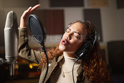 Buy stock photo Music, singing and black woman recording in studio in home, streaming with microphone, headphones and talent. Technology, art and creative influencer or musician with song stream for record label.