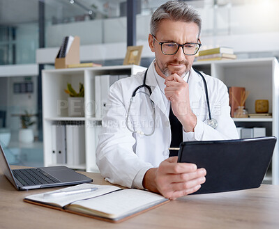 Buy stock photo Thinking doctor, tablet and man in hospital for telehealth, online consultation or healthcare. Medical technology, wellness ideas or mature male physician with digital touchscreen for health research