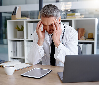 Buy stock photo Doctor, burnout and man with headache in hospital feeling depressed while working on laptop. Mental health, depression and medical professional or physician with stress, pain and anxiety in clinic.