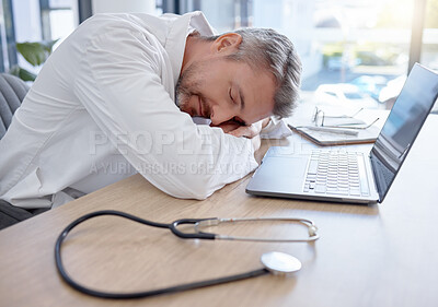 Buy stock photo Man, doctor and laptop sleeping on desk from burnout, overworked or insomnia at the office. Tired male medical professional taking a nap, rest or asleep on table by computer at the workplace